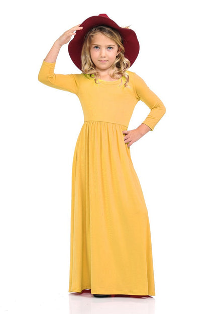 Girls solid peach maxi dress by ModestAndDevoted, featuring a comfortable, flowing design perfect for casual or special occasions.