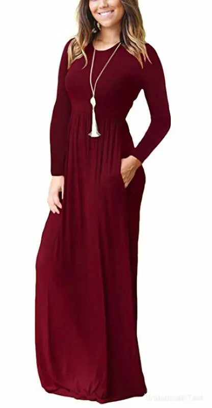 Deep red women's long sleeve maxi dress with pockets by ModestAndDevoted, featuring a flowing silhouette and comfortable design.