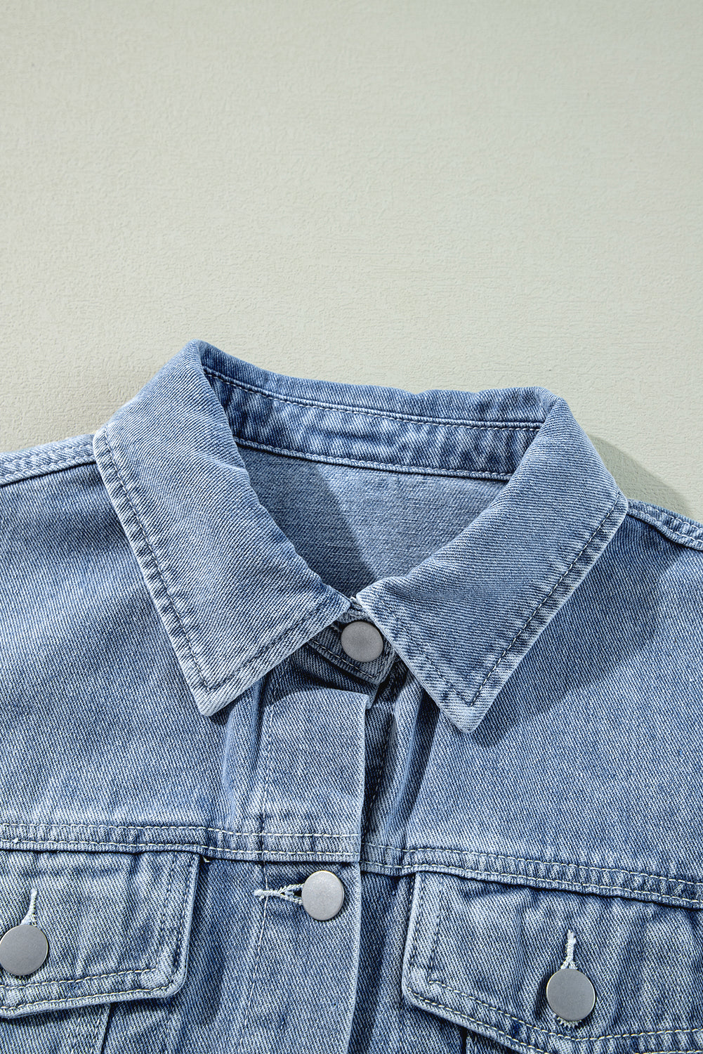 Beau Blue denim jacket with ruffle raw hem, flap pockets, and a stylish outerwear design by ModestAndDevoted.
