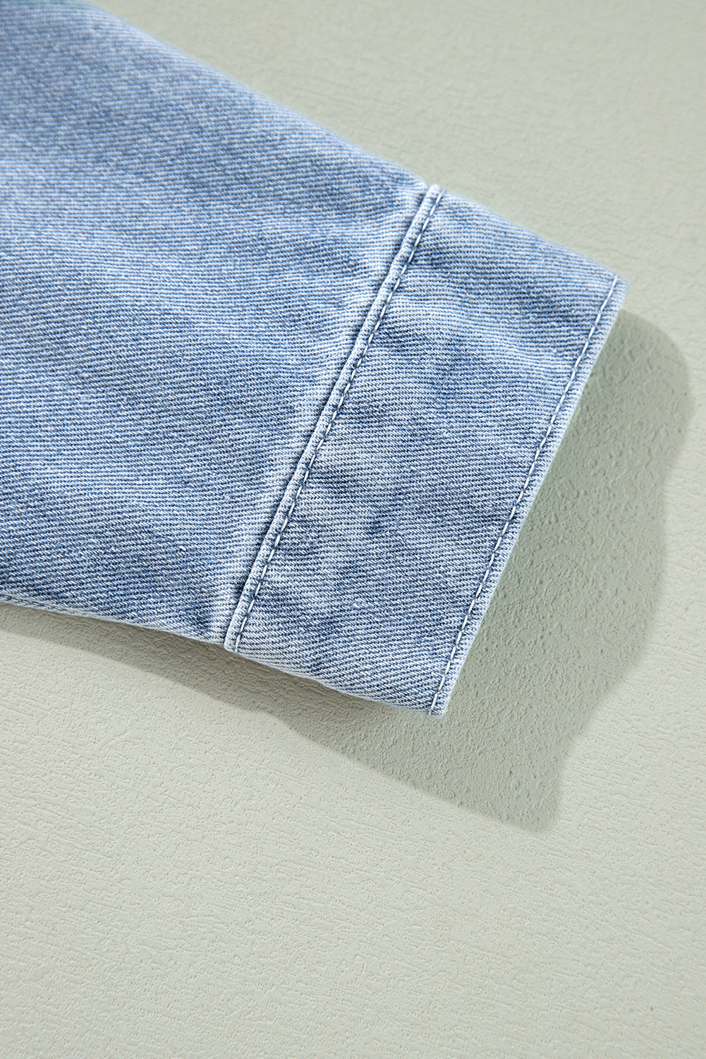 Beau Blue denim jacket by ModestAndDevoted with ruffle raw hem, flap pockets, and classic outerwear style.