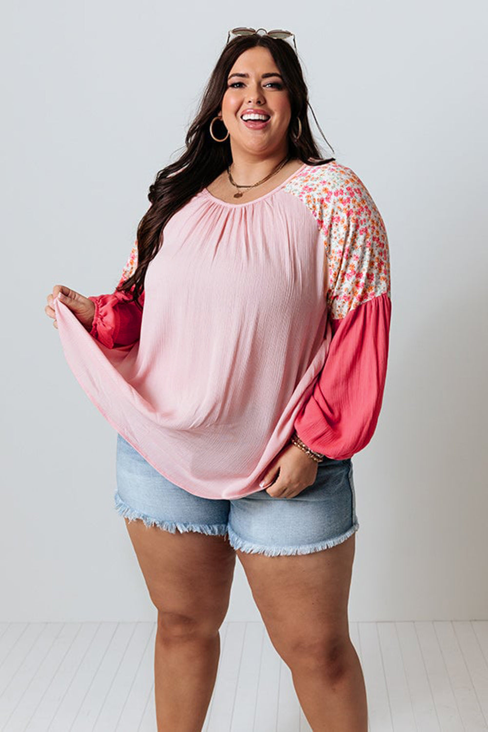 Pink floral patchwork plus size long sleeve blouse by ModestAndDevoted, featuring contrast floral design and relaxed fit.