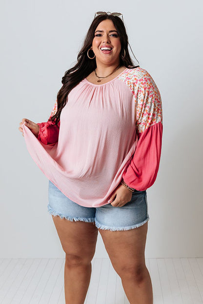 Pink floral patchwork plus size long sleeve blouse by ModestAndDevoted, featuring contrast floral design and relaxed fit.
