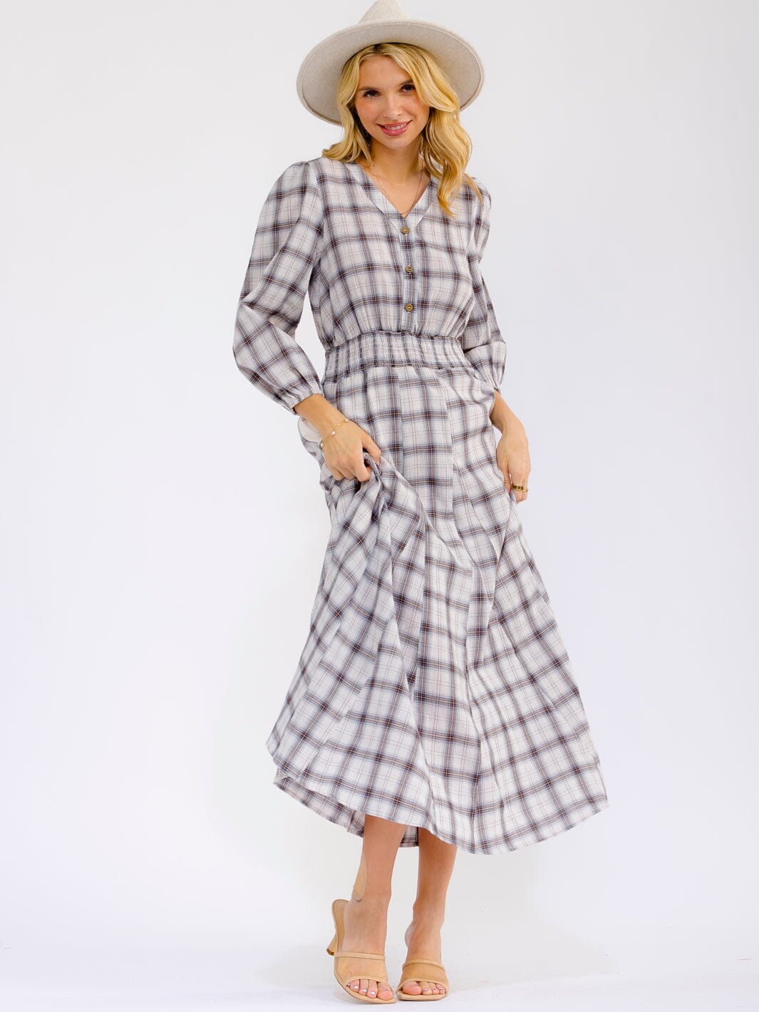 Long sleeve V-neck button-front maxi dress with elastic waist by ModestAndDevoted, shown on a model in a neutral setting.
