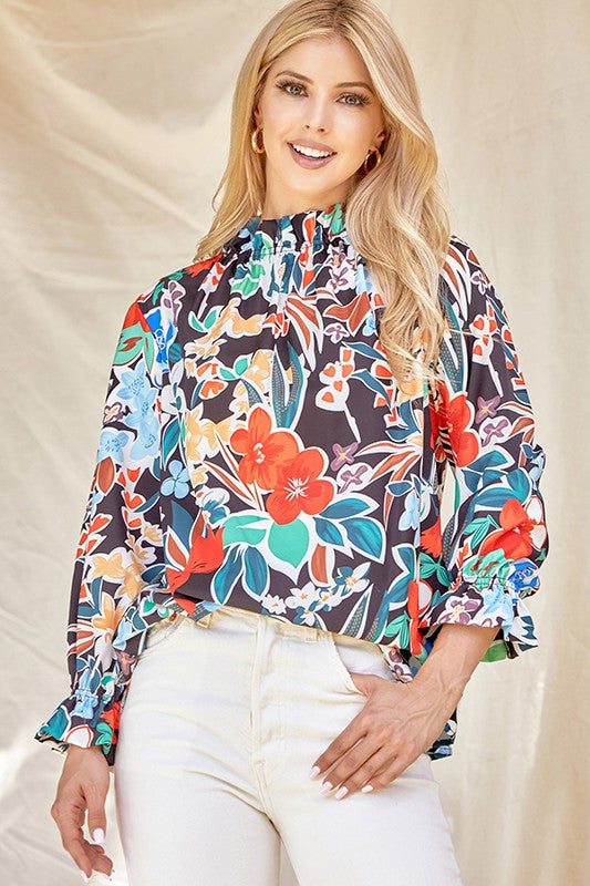 Floral ruffle neck blouse from ModestAndDevoted, featuring a feminine design with ruffle detailing and a stylish neckline.
