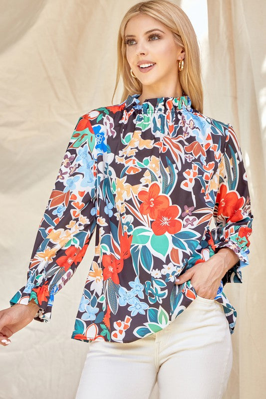 Floral ruffle neck blouse from ModestAndDevoted, featuring lightweight fabric and feminine ruffle details, perfect for casual or dressy wear.