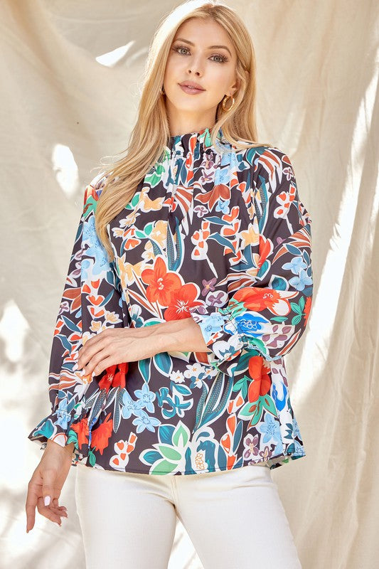 Floral ruffle neck blouse from ModestAndDevoted, featuring a feminine design with soft fabric and ruffle details.