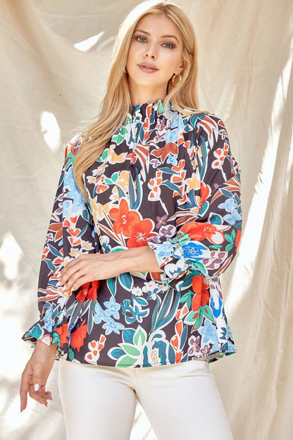 Floral ruffle neck blouse from ModestAndDevoted, featuring a feminine design with soft fabric and ruffle details.