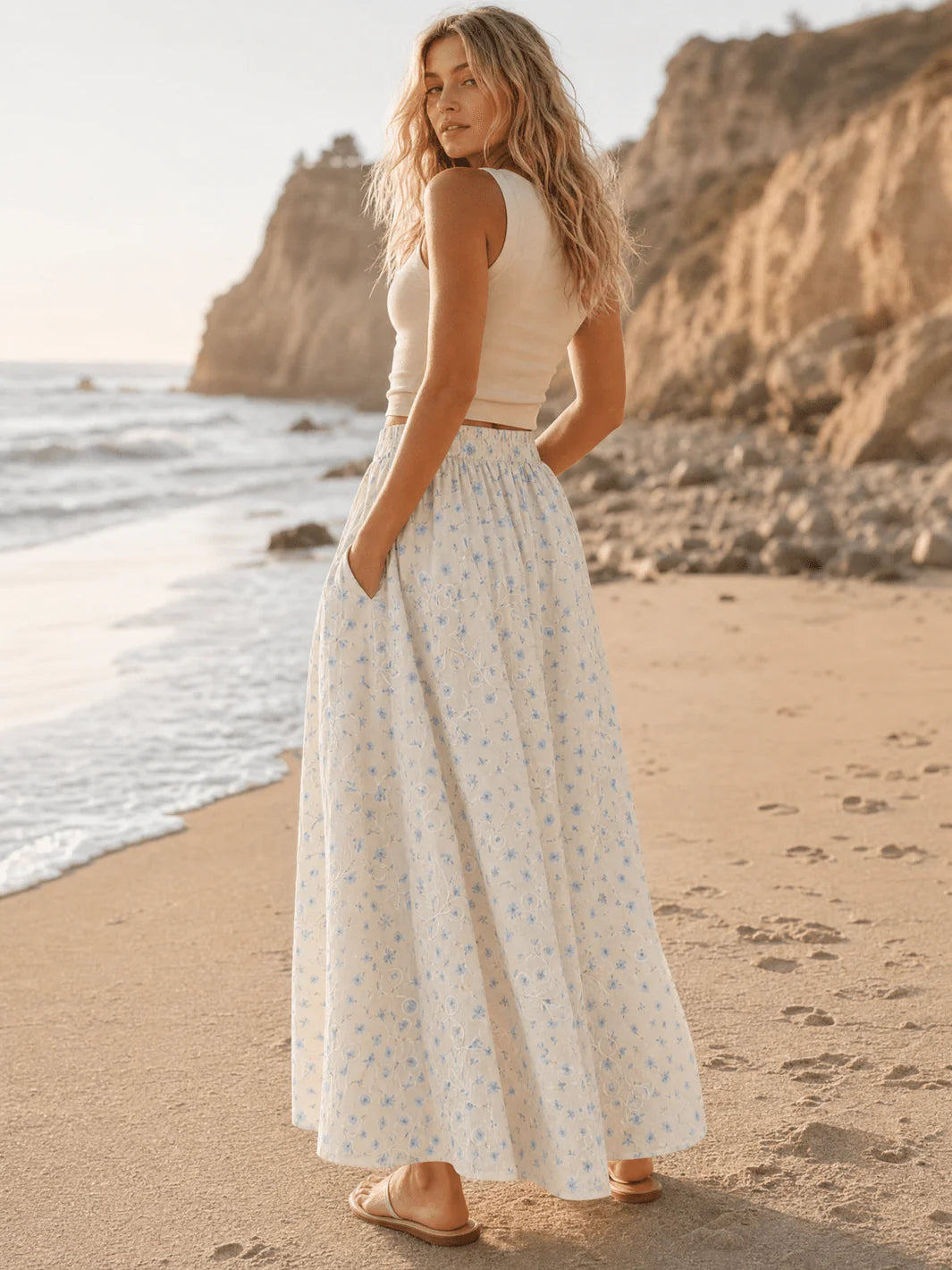 Women's blue floral print maxi skirt with elastic waist by ModestAndDevoted, flowing fabric and vibrant floral pattern.