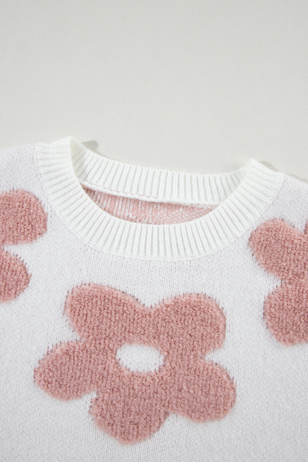 White textured flower drop shoulder loose sweater by ModestAndDevoted, featuring a relaxed fit with floral details.