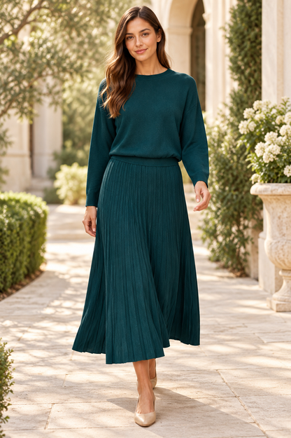Forest teal high-waisted pleated midi skirt from ModestAndDevoted, shown with a boat neck dolman sleeve ribbed sweater.