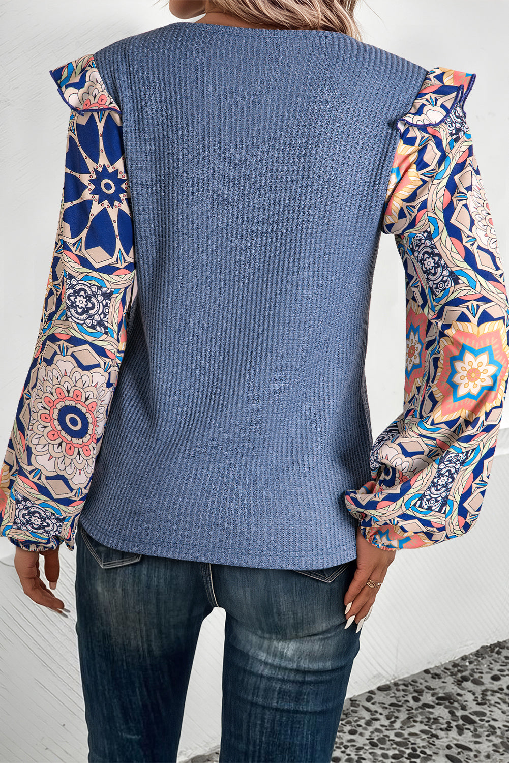 Ashleigh Blue Ruffled Floral Sleeve Patchwork Waffle Knit O Neck Blouse by ModestAndDevoted, featuring floral ruffles and patchwork details.