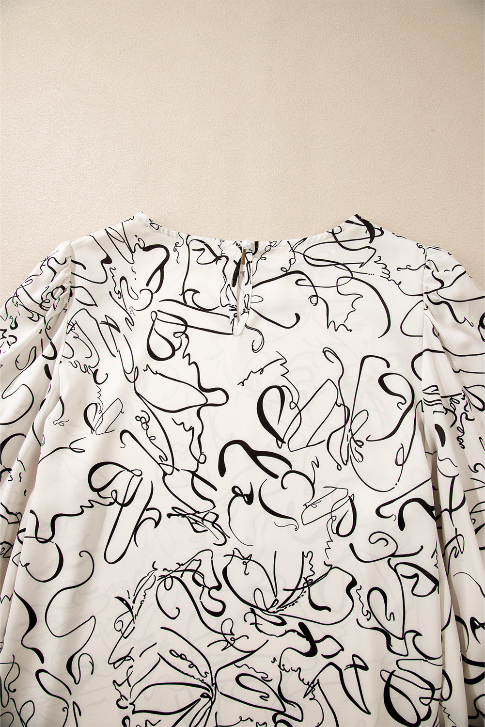 Beige abstract print balloon sleeve crew neck blouse by ModestAndDevoted, made of polyester, featuring a stylish, relaxed fit.