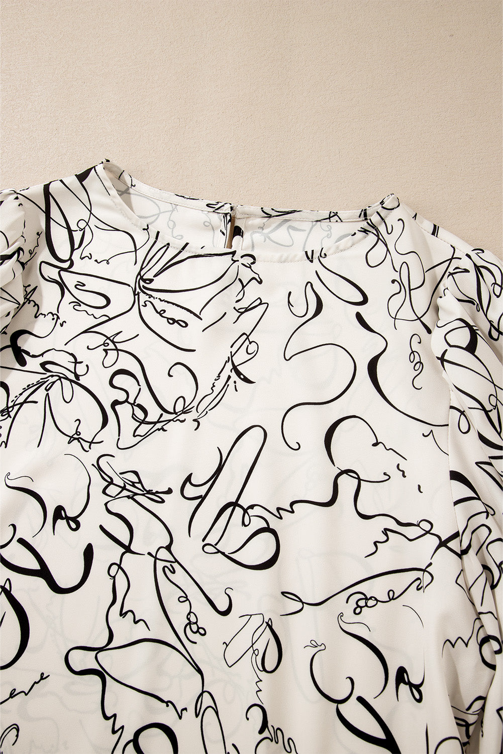 Beige abstract print balloon sleeve crew neck blouse from ModestAndDevoted, made of lightweight polyester with stylish design.