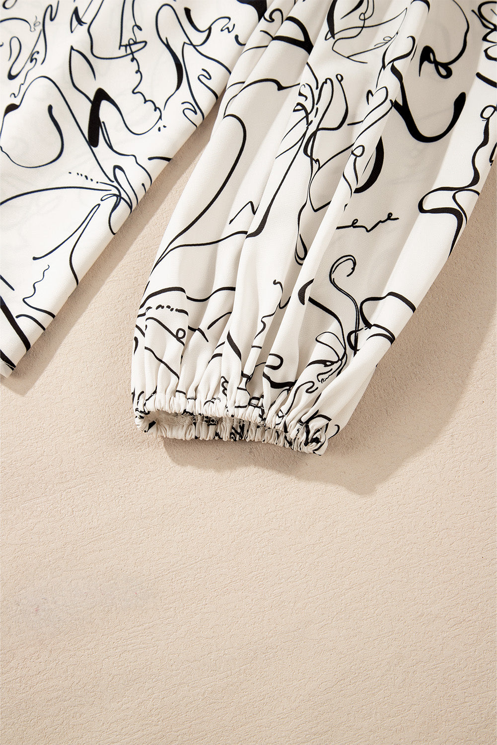 Beige abstract print balloon sleeve crew neck blouse by ModestAndDevoted, featuring a stylish design and comfortable fit.