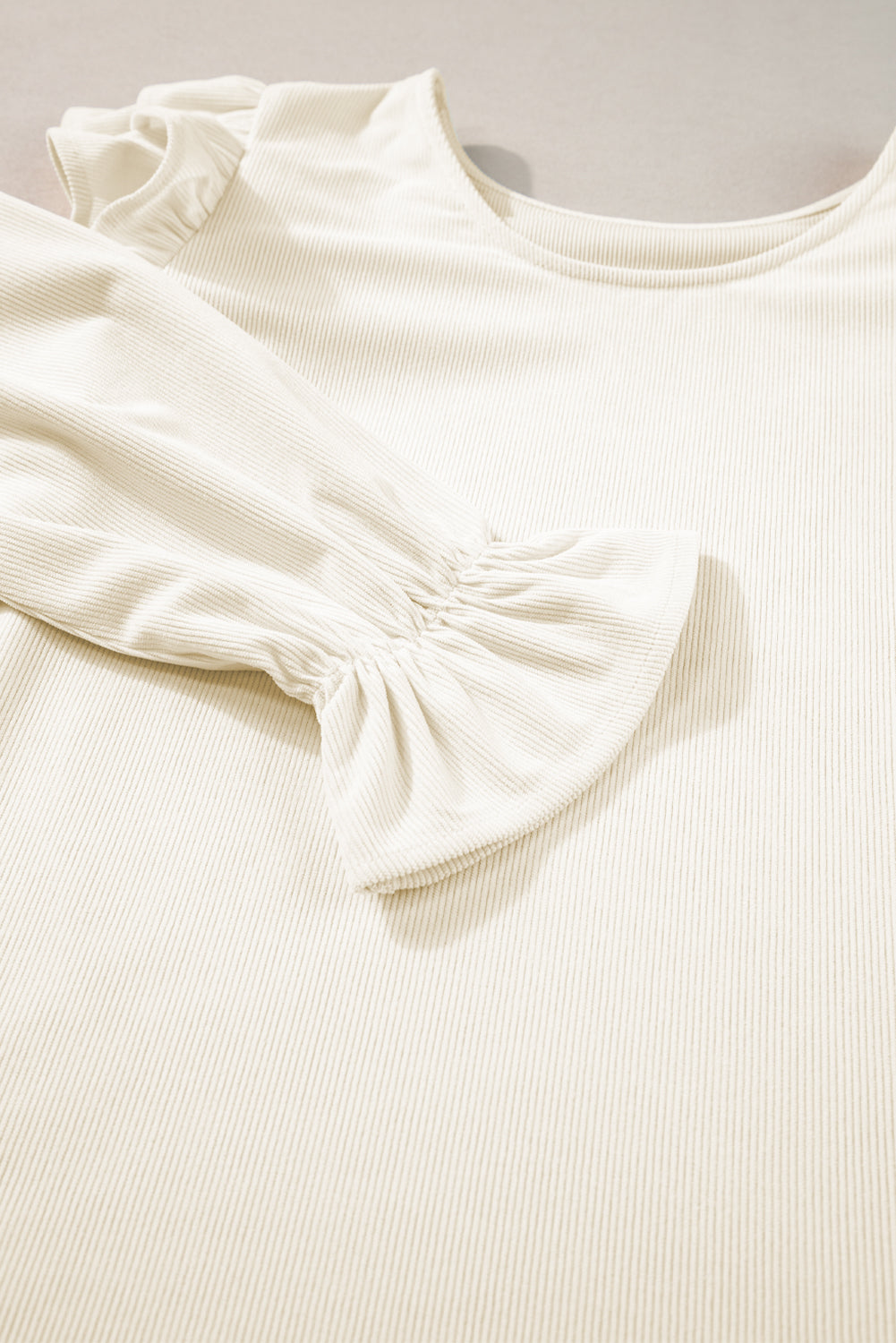 Beige ruffled flounce sleeve corduroy blouse by ModestAndDevoted, featuring textured fabric and elegant ruffle details.