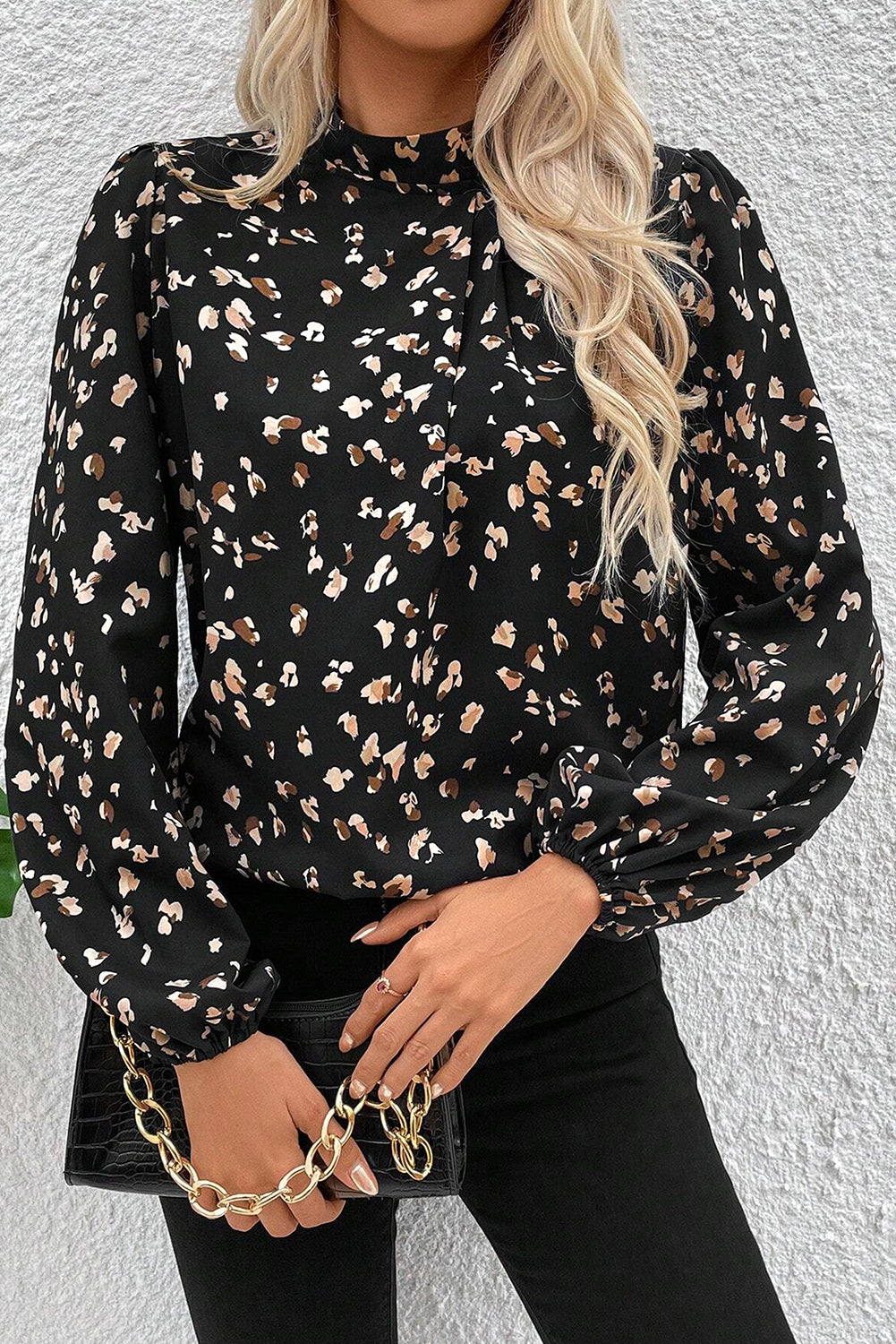 Black leopard print lantern sleeve mock neck blouse with pleats from ModestAndDevoted, shown on a hanger.