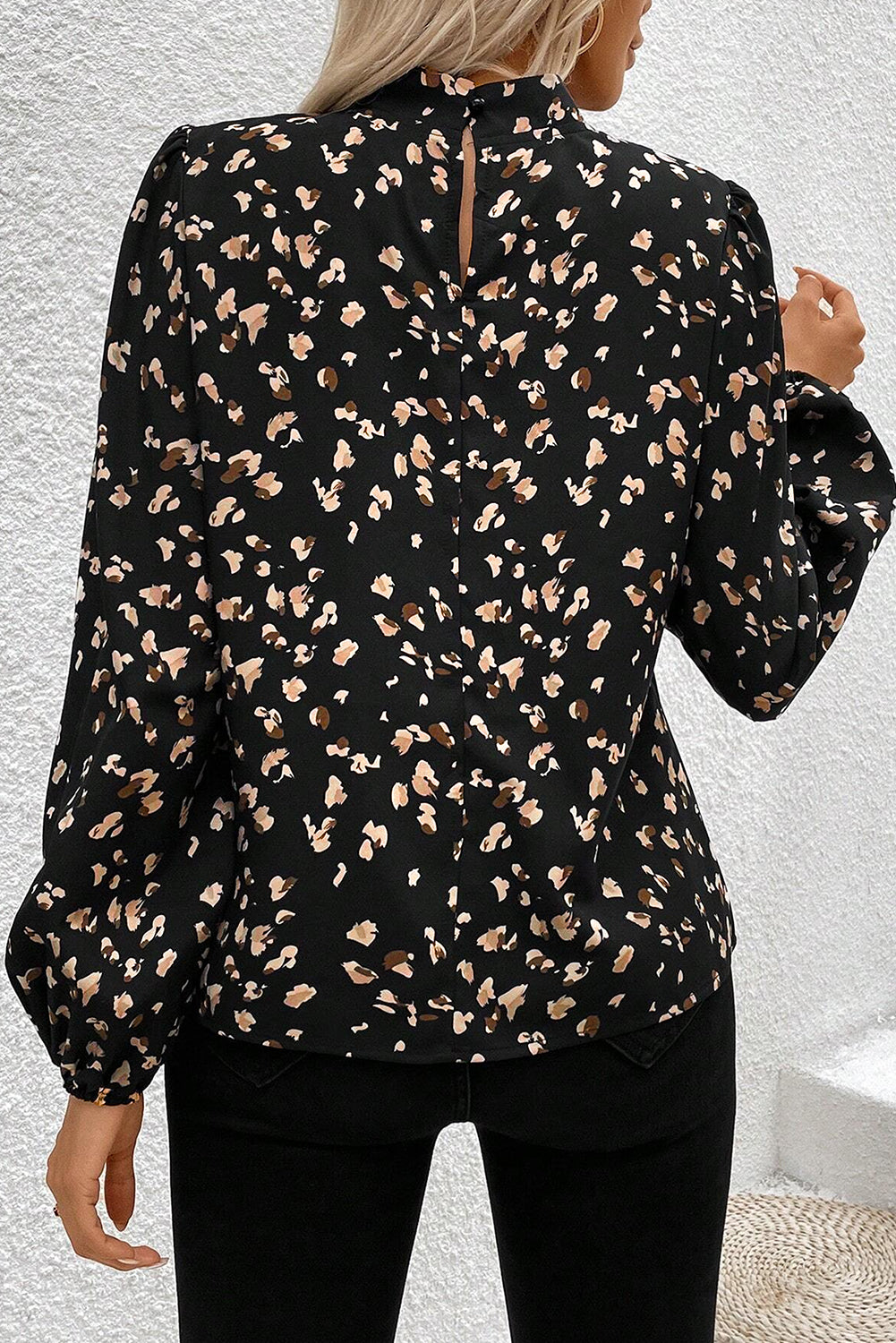 Black leopard print lantern sleeve mock neck blouse with pleats from ModestAndDevoted, shown on a hanger.