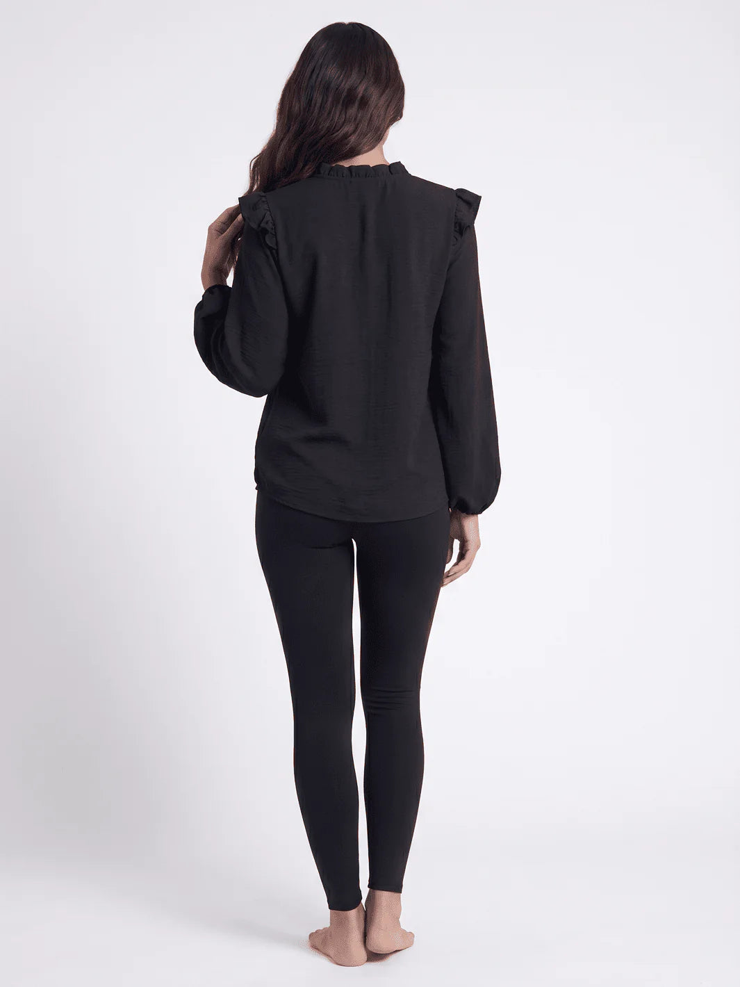 Black long sleeve V-neck blouse with ruffle shoulder detailing from ModestAndDevoted, available in assorted colors.