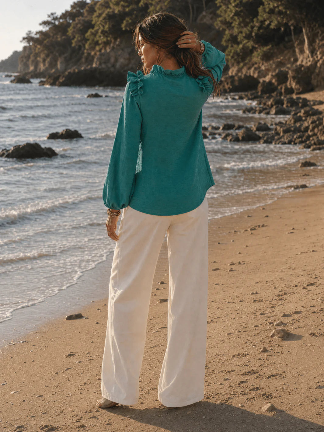 Black long sleeve V-neck blouse with ruffle shoulders from ModestAndDevoted, shown in assorted colors, styled as a fashionable top.