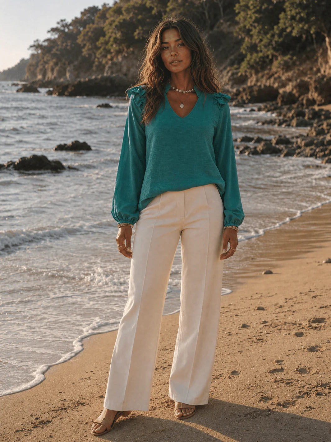 Black long sleeve V-neck blouse with ruffle shoulders from ModestAndDevoted, shown with assorted color options and detailed fabric.