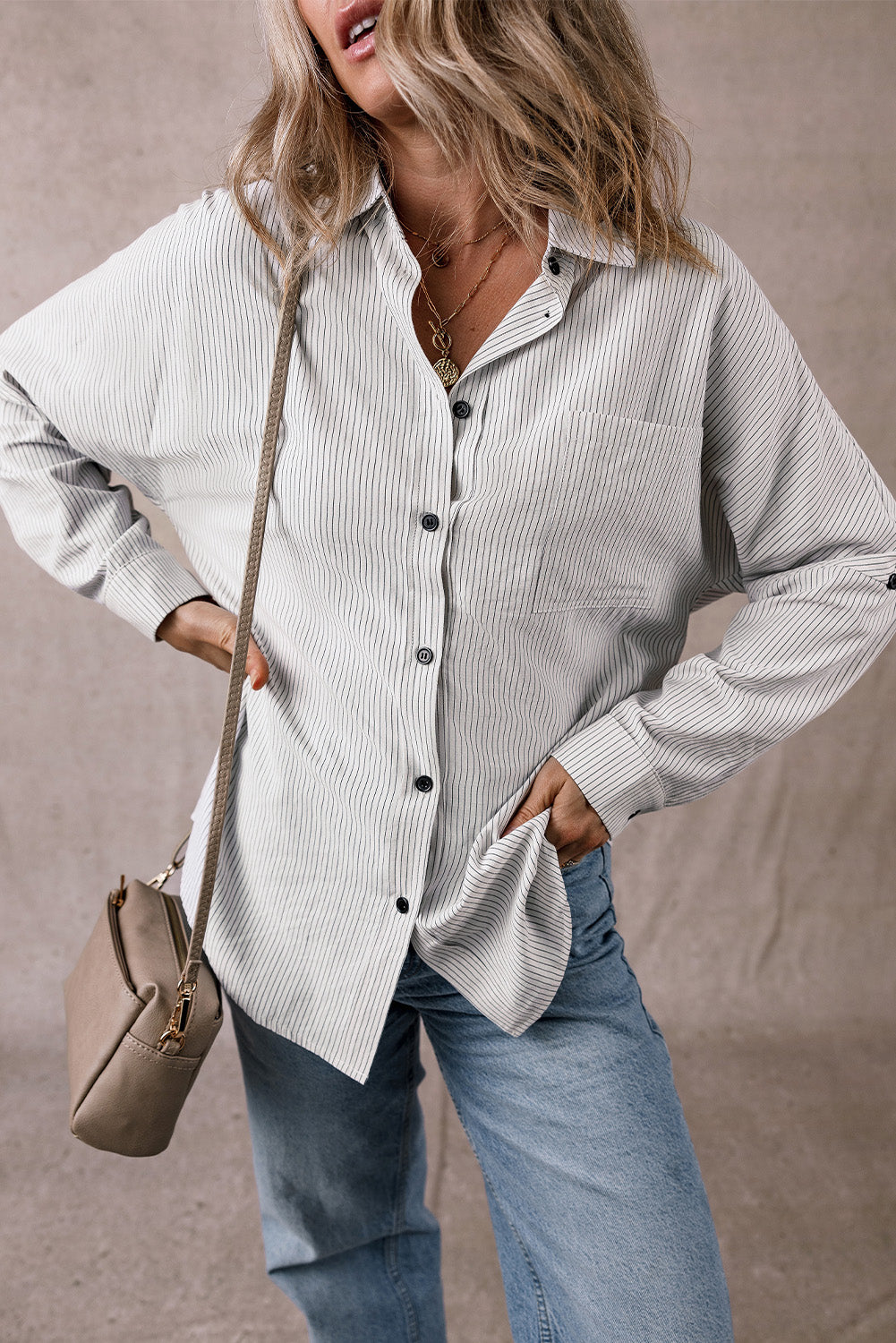 Black stripe long shirt with roll-tab sleeves and front pockets from ModestAndDevoted, made of polyester and cotton blend.