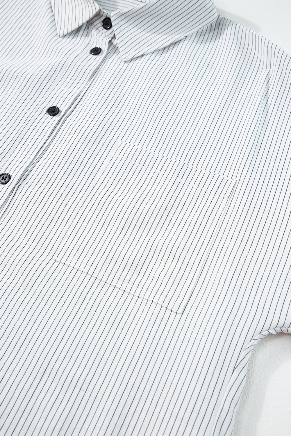 Black stripe roll-tab sleeve long shirt by ModestAndDevoted, featuring chest pockets and a stylish, comfortable blouse design.