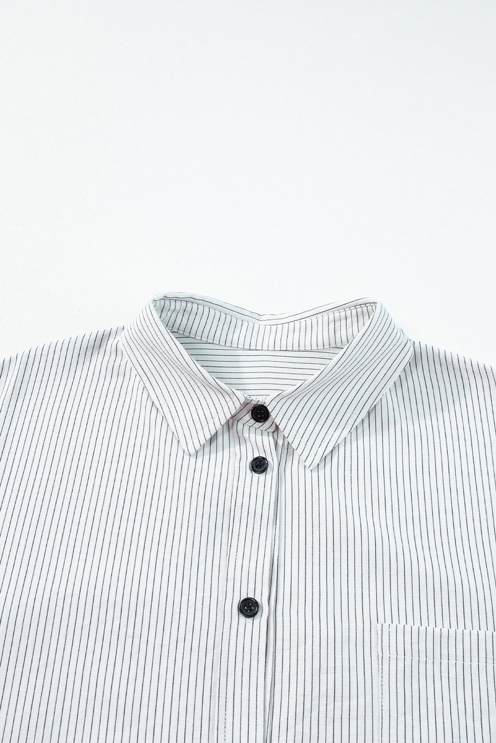 Black stripe long shirt with roll-tab sleeves and pocket details, made by ModestAndDevoted, in polyester and cotton blend.