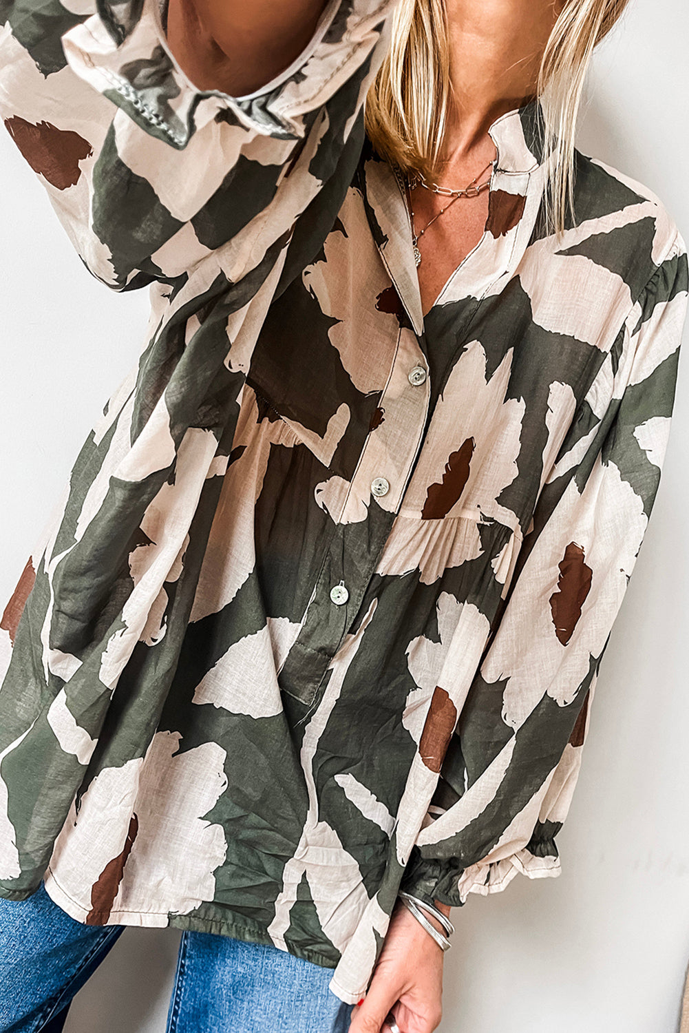 ModestAndDevoted floral print puff sleeve blouse with four-leaf clover abstract design, half-button front, made of polyester.