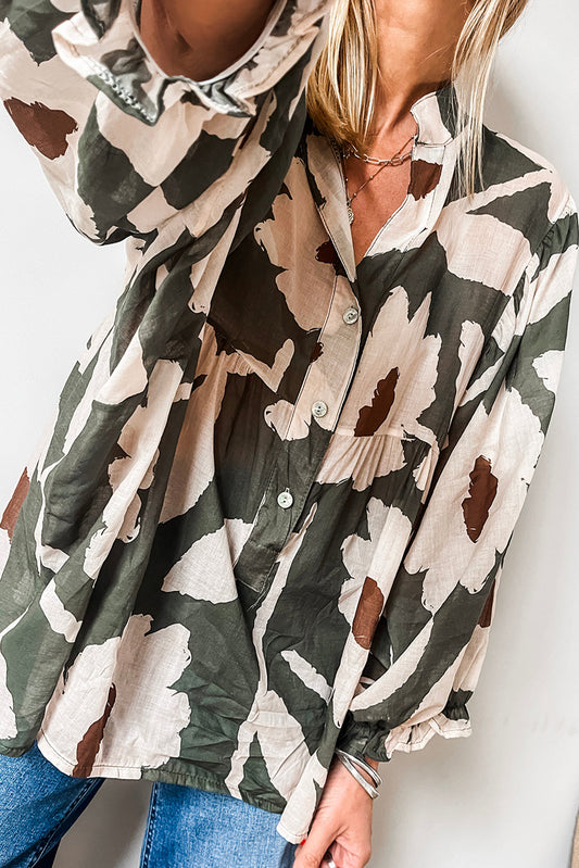 ModestAndDevoted floral print puff sleeve blouse with four-leaf clover abstract design, half-button front, made of polyester.