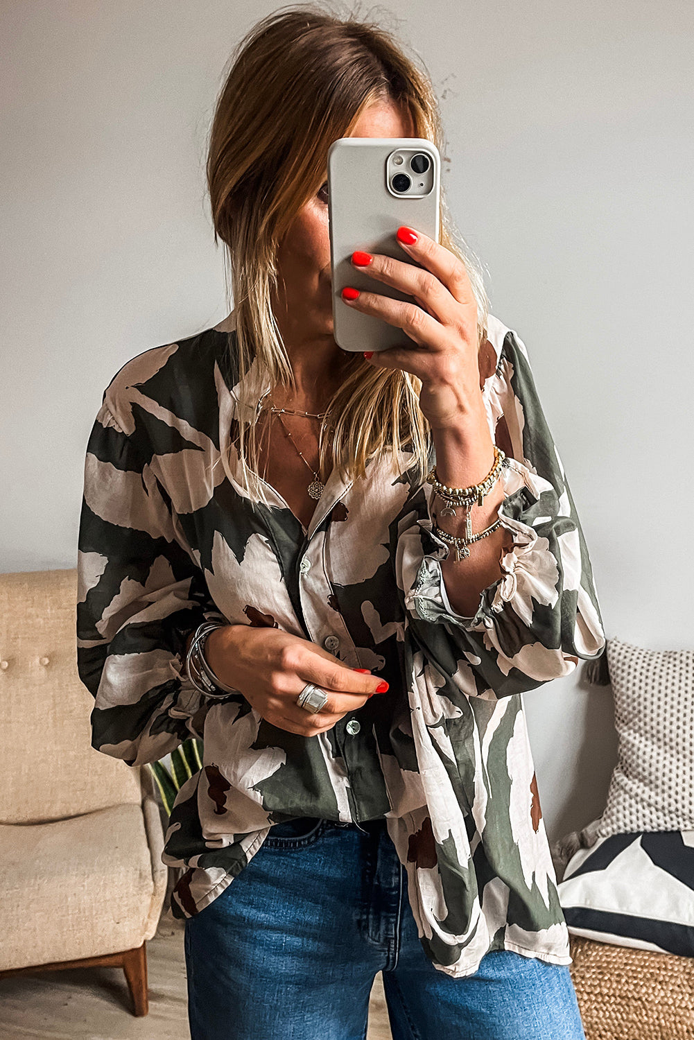 ModestAndDevoted floral print puff sleeve blouse with four-leaf clover design, half-button front, made of polyester fabric.