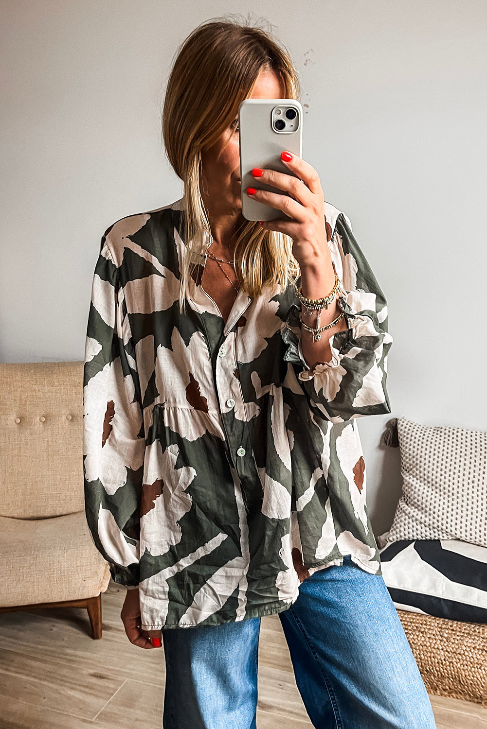 ModestAndDevoted floral print puff sleeve blouse with four-leaf clover abstract design, half button front, polyester fabric.