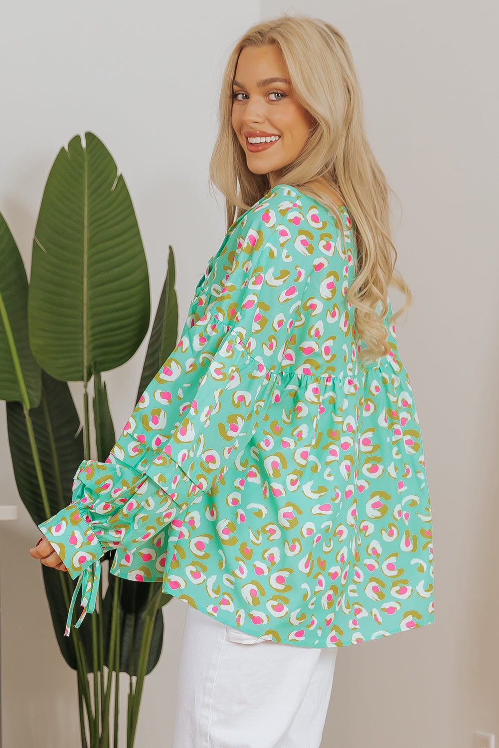 Green abstract printed lace-up lantern sleeve babydoll blouse by ModestAndDevoted, featuring a flowy silhouette and stylish design.