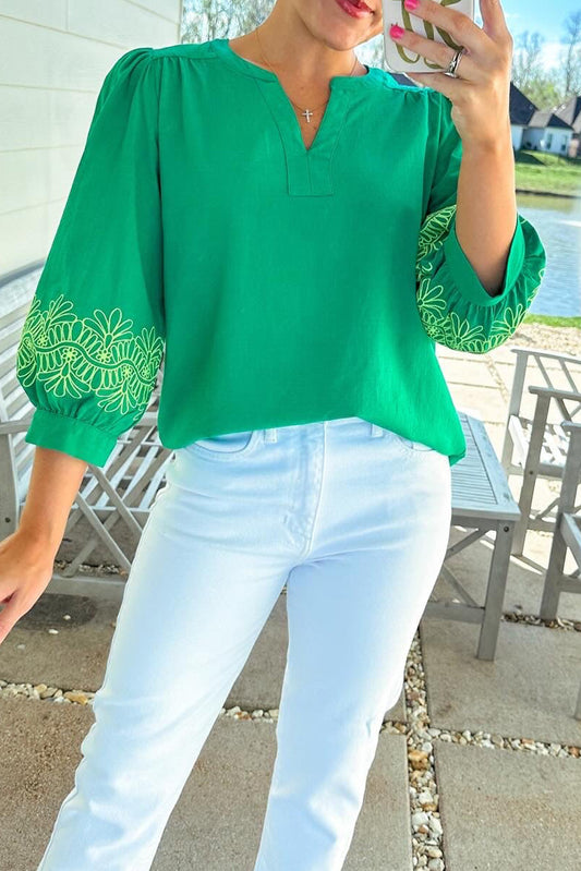 Green floral embroidered blouse from ModestAndDevoted featuring 3/4 sleeves, notched V-neck, and elegant contrast details.