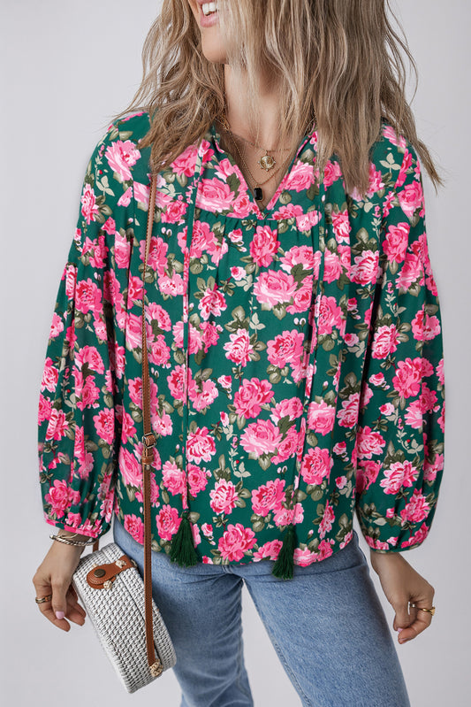 Green floral printed blouse with tied collar and puff sleeves from ModestAndDevoted, made of lightweight polyester fabric.