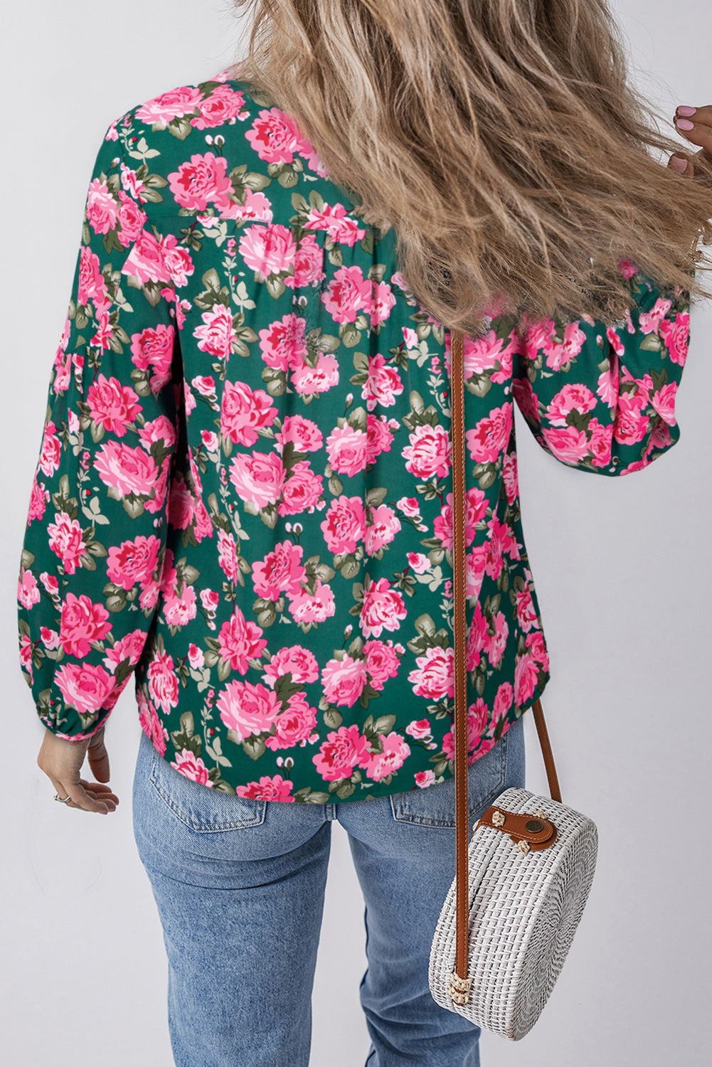 Green floral printed blouse with tied collar and puff sleeves by ModestAndDevoted, made of lightweight polyester fabric.