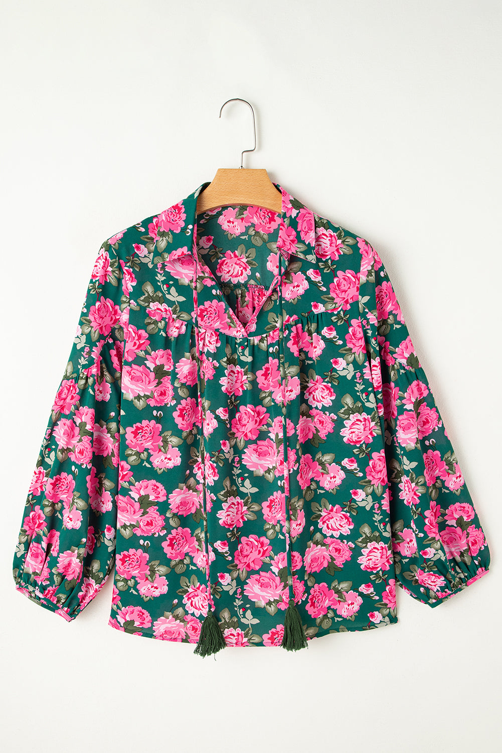 Green floral printed blouse with tied collar and puff sleeves from ModestAndDevoted, made of lightweight polyester fabric.