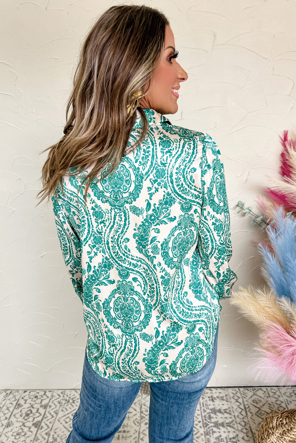 Green paisley print blouse by ModestAndDevoted with smocked cuffs, buttoned front, loose fit, made of polyester.