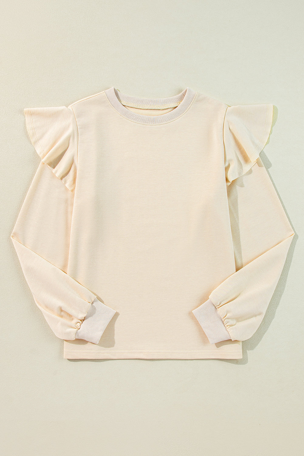 ModestAndDevoted Jet Stream solid color ruffled shoulder long sleeve blouse, stylish women’s top with polyester, cotton, and elastane.