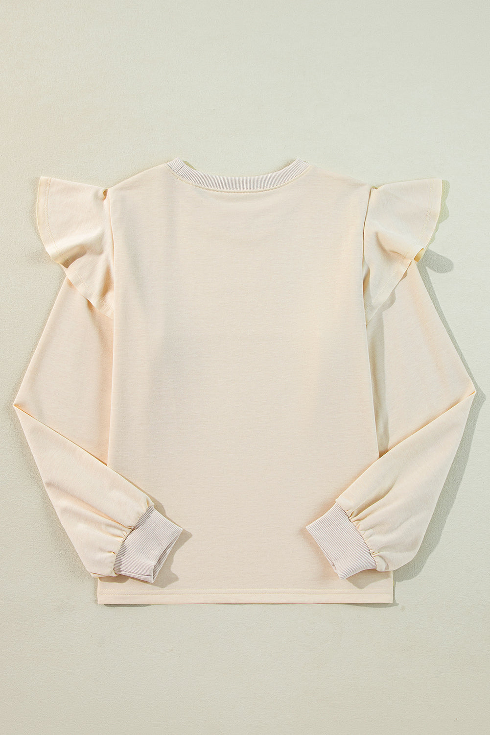 ModestAndDevoted Jet Stream solid color ruffled shoulder long sleeve blouse, made of polyester, cotton, and elastane fabric.