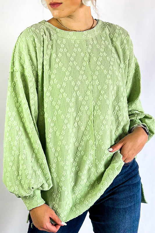 Light green textured solid color blouse with side split and crew neck from ModestAndDevoted, made of polyester and elastane.