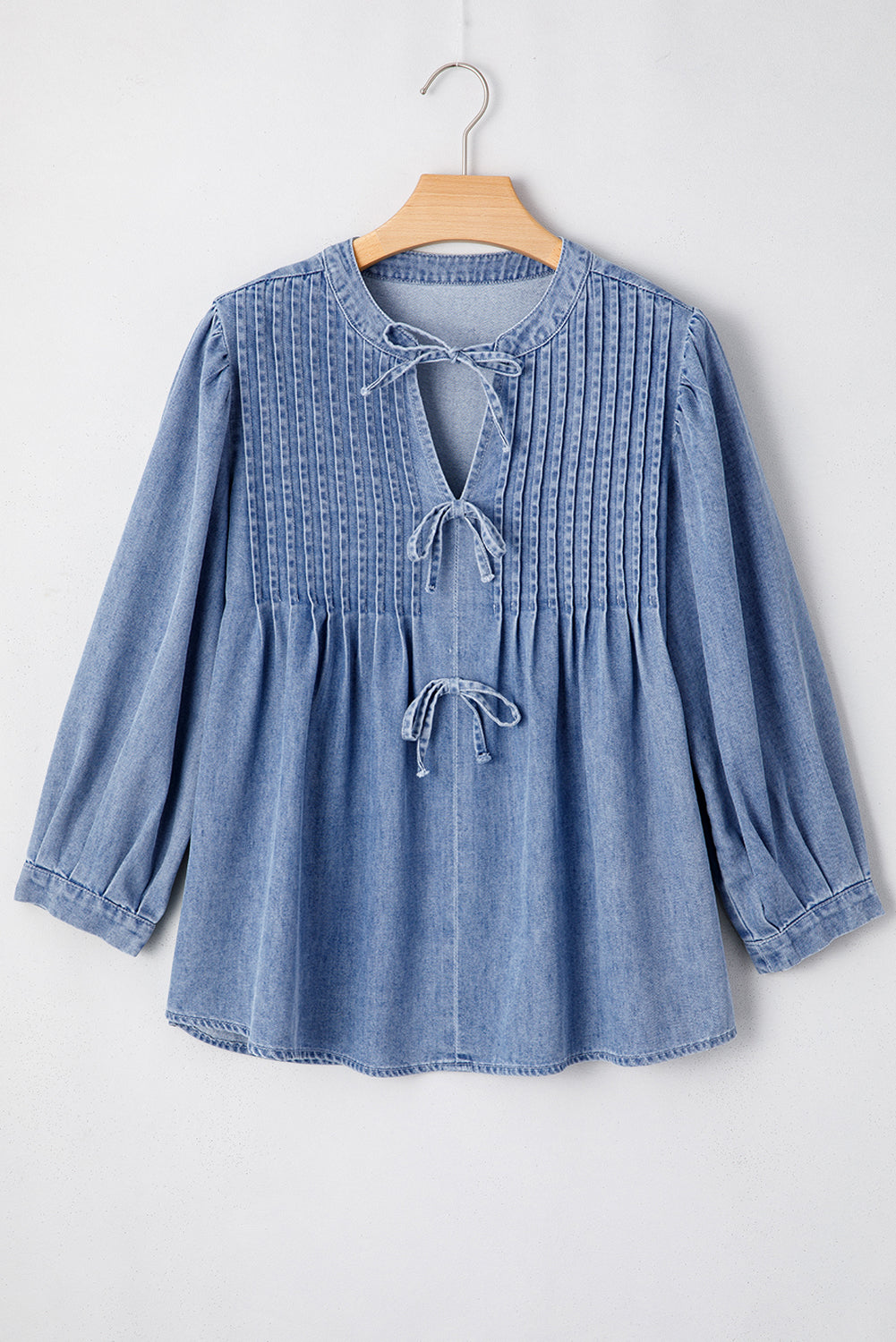 Myosotis denim puff sleeve top with front pintuck detail and bow tie, made of cotton-polyester blend, by ModestAndDevoted.
