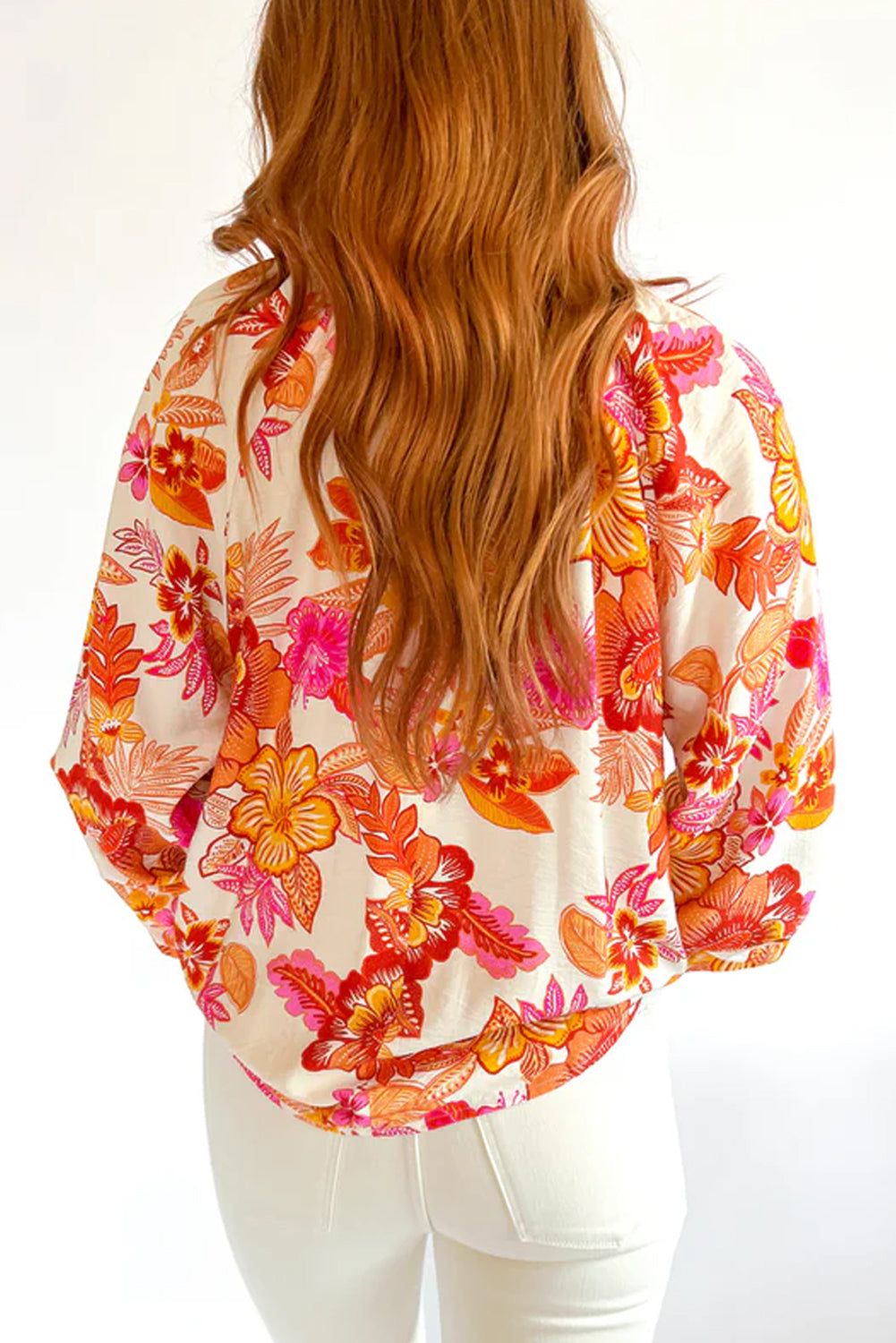 Orange floral print blouse with pearl buttons, keyhole neckline, and long puff sleeves, by ModestAndDevoted.