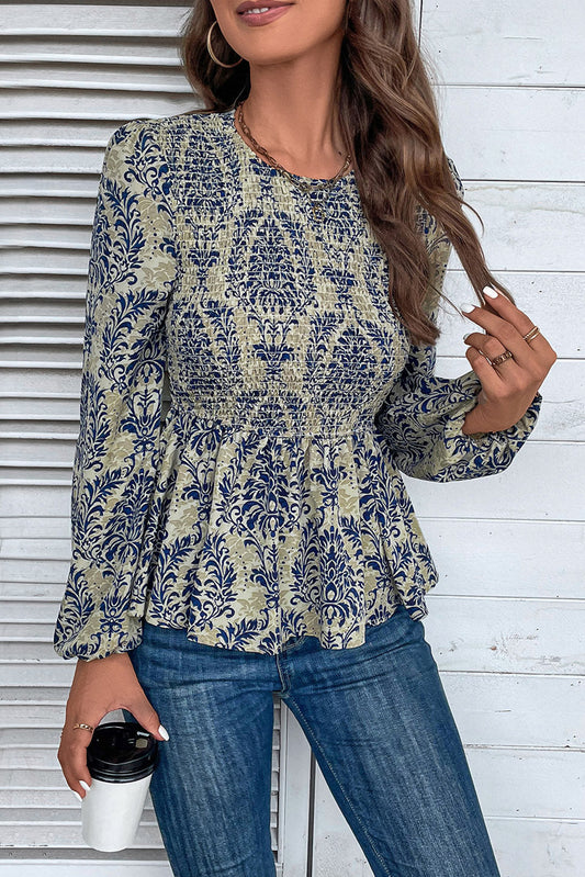Sky blue boho printed balloon sleeve smocked peplum blouse from ModestAndDevoted, shown with detailed fabric and stylish design.