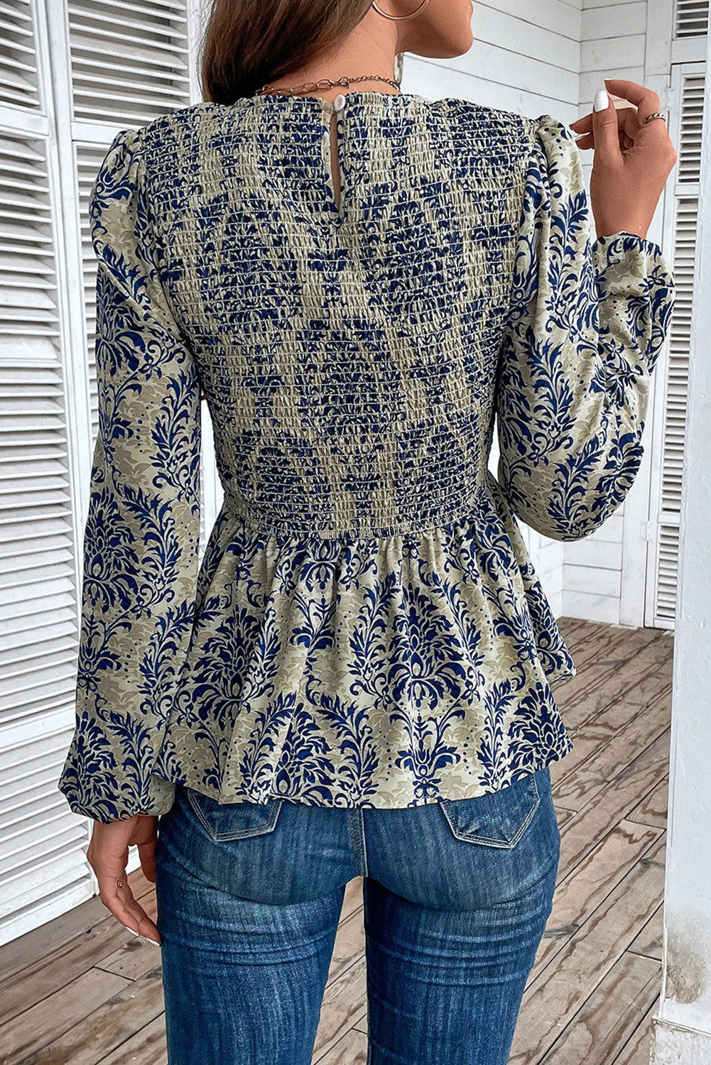 Sky blue boho printed balloon sleeve smocked peplum blouse from ModestAndDevoted, featuring lightweight polyester fabric and stylish design.