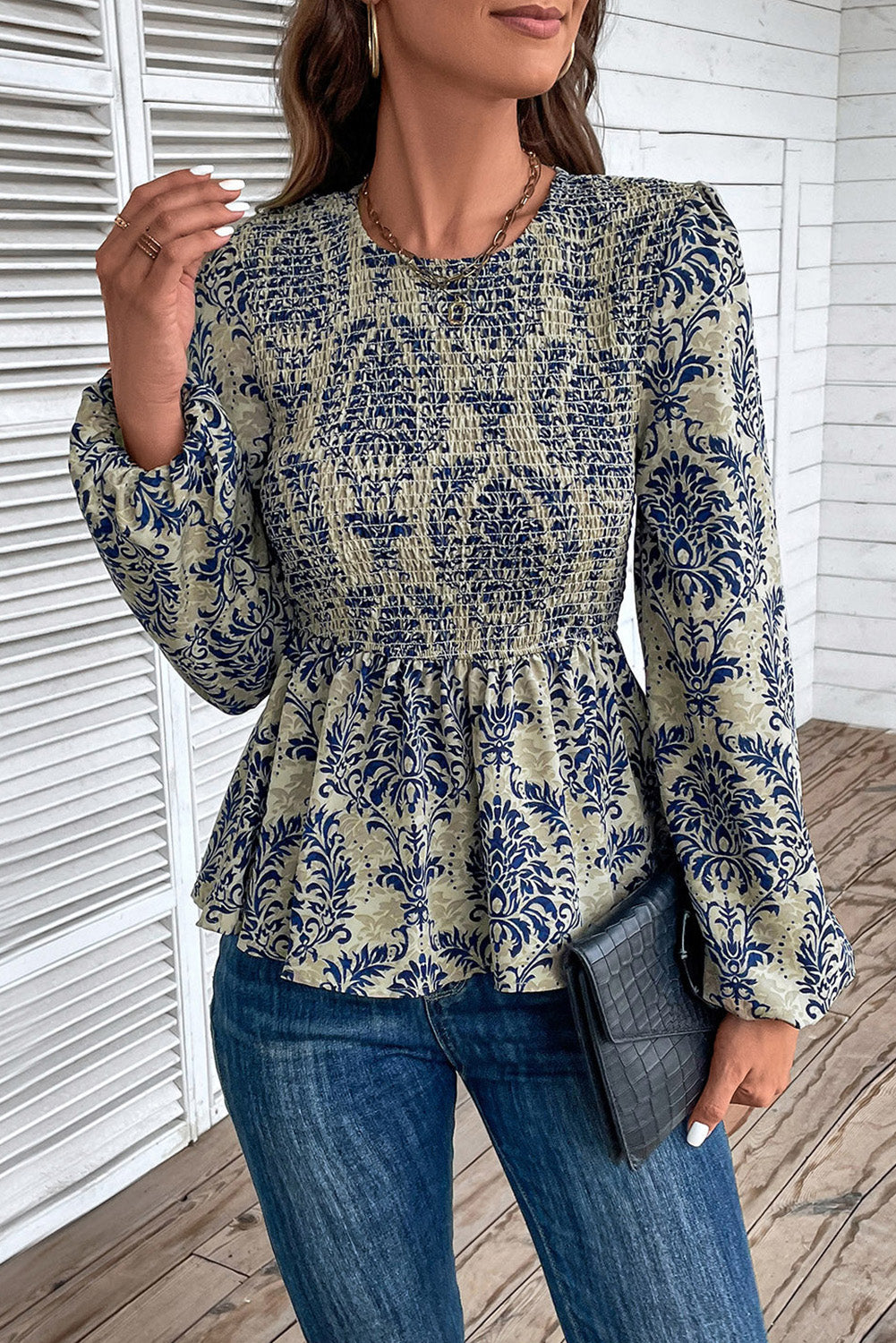 Sky blue boho printed balloon sleeve smocked peplum blouse by ModestAndDevoted, featuring floral pattern and ruffled details.