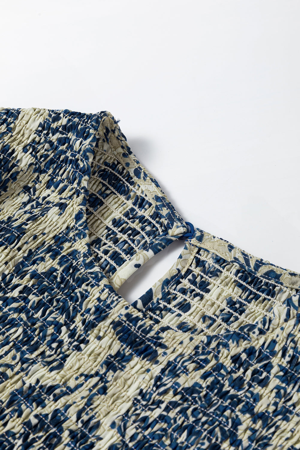Sky blue boho printed balloon sleeve smocked peplum blouse from ModestAndDevoted, shown on a hanger with detailed fabric pattern.