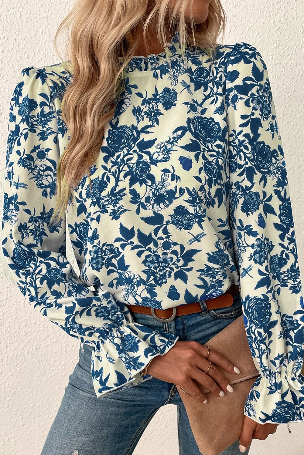 Sky blue floral print blouse with flounce sleeves and keyhole back from ModestAndDevoted, made of lightweight polyester.
