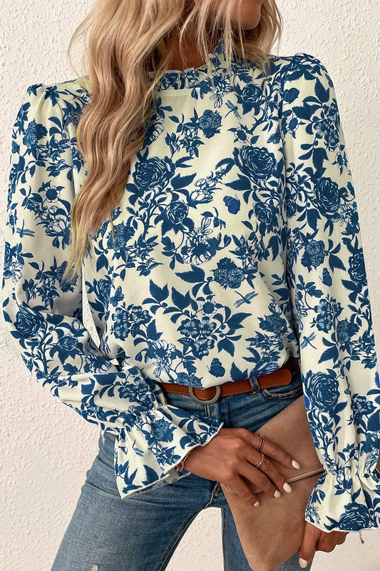 Sky blue floral print blouse with flounce sleeves and keyhole back from ModestAndDevoted, made of lightweight polyester.