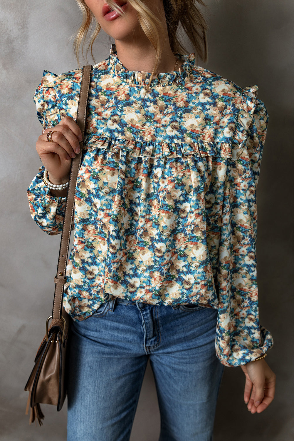 Sky blue floral print blouse with frilled mock neck and puff sleeves by ModestAndDevoted, made of 100% polyester.