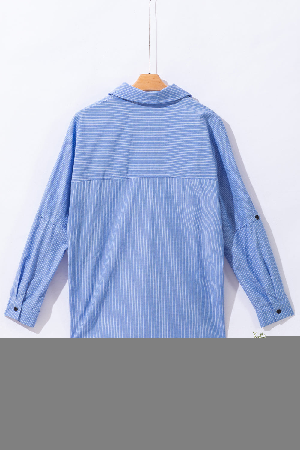 Sky blue striped long shirt with roll-tab sleeves and chest pockets from ModestAndDevoted, made of polyester and cotton blend.